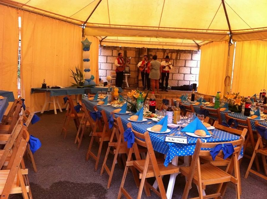 Musicians playing for guests in a decorated celebration tent